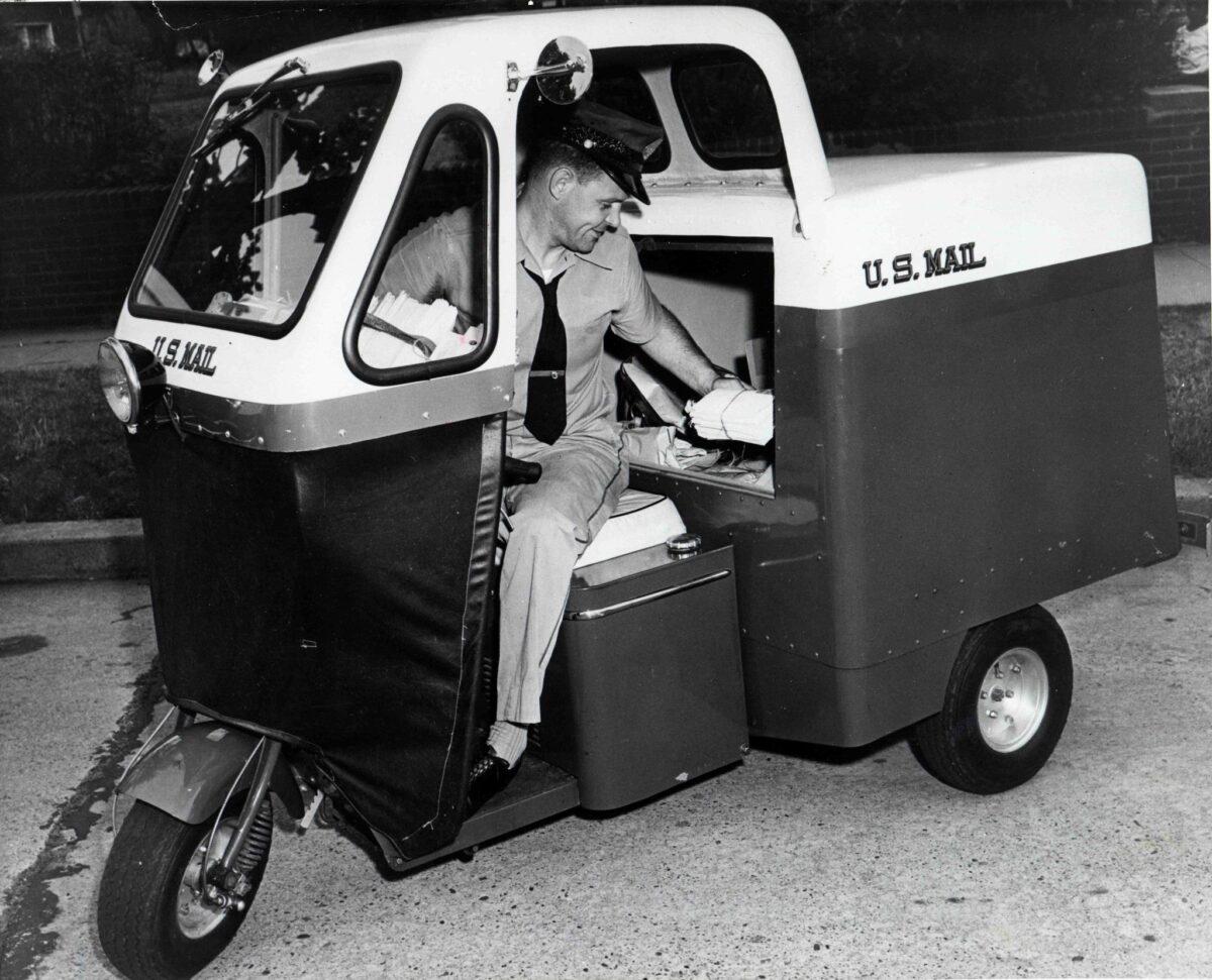 Mailster three wheel car handing over mail in 1955 vintage