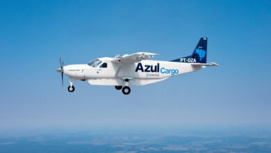 A small Caravan turboprop in blue Azul lettering flying against blue sky.