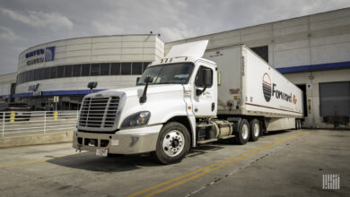 A Forward Air tractor-trailer backed up to a United Airlines cargo terminal