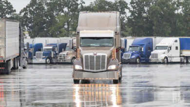 Several trucks in the rain at a truckstop