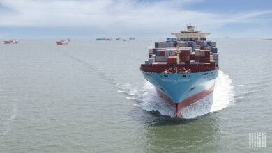 A Maersk container ship cruises outside Galveston, Texas, with other container ships seen in the background.