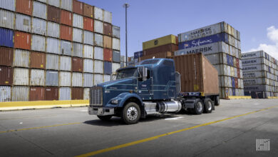 Truck hauling container from port