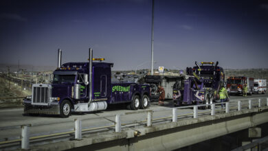 Wrecker towing a truck from crash site.