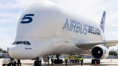 Front view of white Airbus Beluga plane with a jutting fuselage for oversize loads.