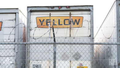 Yellow trailers parked along a fence at a Houston terminal