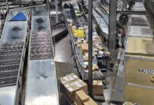 Packages moving through a conveyor system in a warehouse.