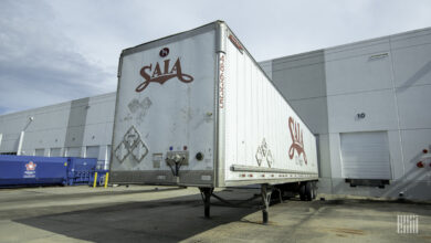 A white Saia trailer backed into a dock door