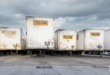 Several Yellow trailers at a terminal