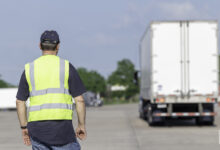 Truck driver instructor in parking lot.