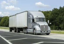 A grey Knight Transportation tractor pulling two LTL trailers