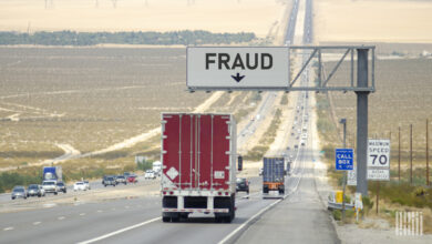 Truck on highway with fraud sign