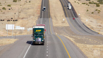 A green ABF Freight tractor pulling a trailer on a highway