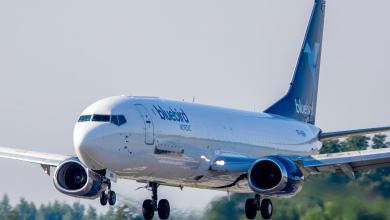 A blue-tailed Bluebird Nordic jet ready to touch down on runway, view from the front.