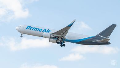 A blue-tailed Prime Air cargo jet rises into the sky.