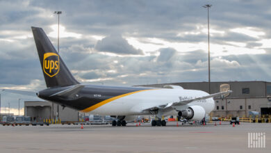A brown-tail UPS freighter parked at an airport terminal.