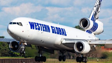 A tri-engine jet with Western Global logo touches down at an airfield.