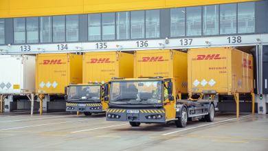 Yellow DHL trucks at a loading dock.