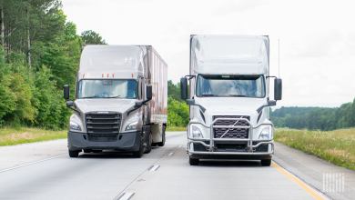 A front view of two tractor-trailers on a highway