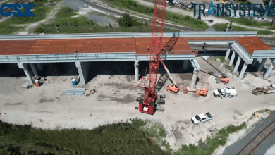 Image shows aerial view of railroad bridge under construction.