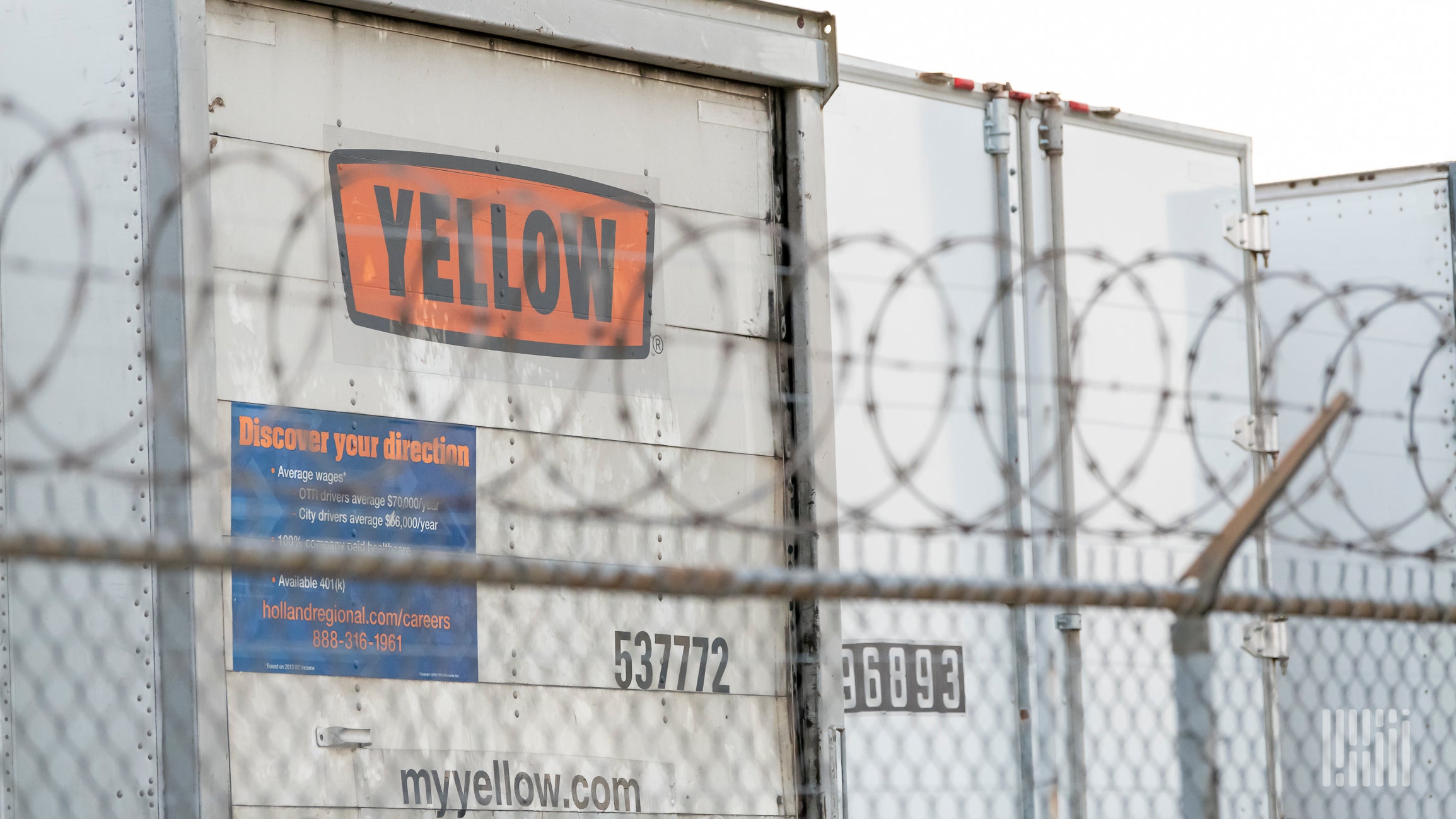 Trailers parked along a fence at a Yellow terminal