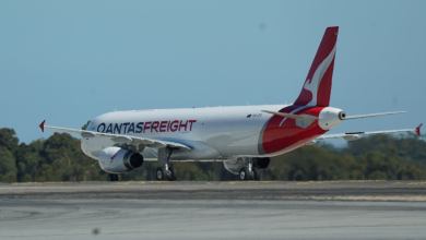 A red-tailed Qantas freighter, as seen on the ground from the rear.
