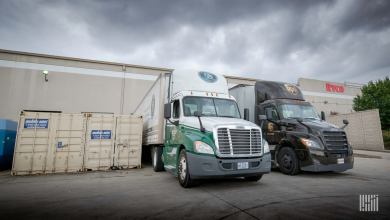 An Old Dominion truck and a UPS Freight truck being loaded at a warehouse