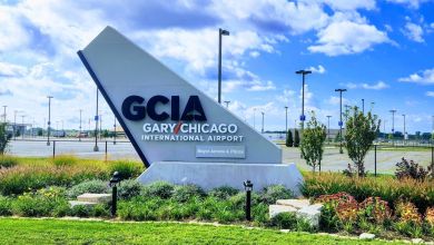 Entrance sign to Gary/Chicago International Airport with blue sky in background.