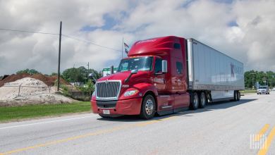 A red Knight sleeper cab pulling a white Knight dry van trailer