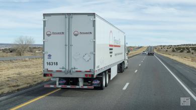 A white Forward Air dryvan trailer being pulled on a highway