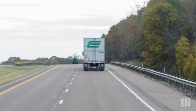 A rearview of a Cowan trailer being pulled on a highway