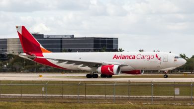 An Avianca Cargo jet with red color scheme moves down the runway.