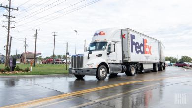 A FedEx tractor pulling two FedEx pup trailers