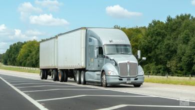 A Knight tractor pulls two pup trailers on a highway