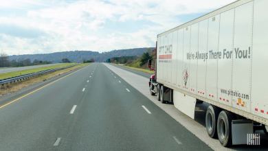 A Pitt Ohio tractor pulling a Pitt Ohio trailer on a highway