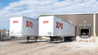 A pair of XPO trailers at a warehouse