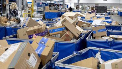 Packages piled in bins at a U.S. Postal Service facility.