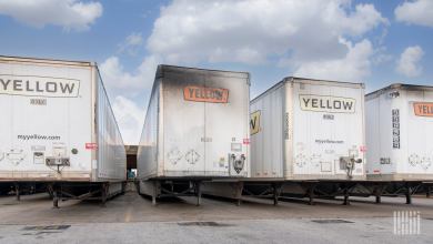Faded signage and exhaust stains on Yellow trailers parked at a terminal