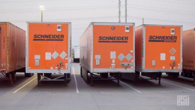 Orange Schneider trailers parked at a facility
