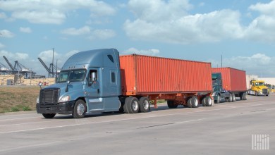 Tractors pulling ocean containers near a port