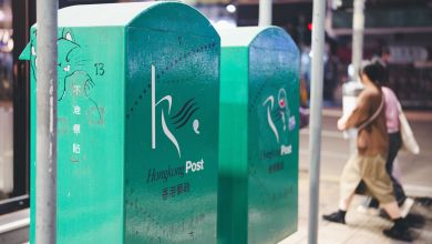 Street view of green Hongkong Post drop boxes.