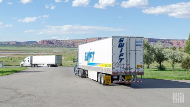 A Swift tractor-trailer leaving a parking lot