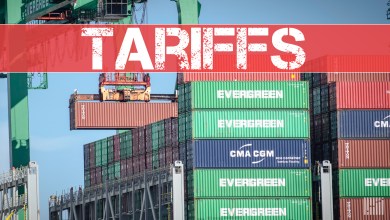 containers at port with tariff banner
