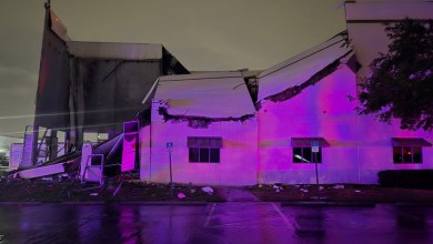 Night view of a collapsed wall at a Post Office facility.