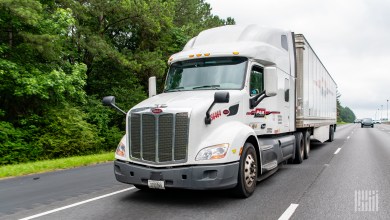 A white Pam Transportation tractor and trailer on the highway