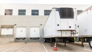 A refrigerated trailer docked at a warehouse