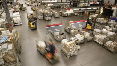 Bins of mail inside a Canada Post mail processing center.