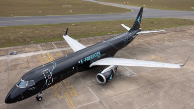 Overhead view of a black E-Freighter from Embraer resting on a tarmac.