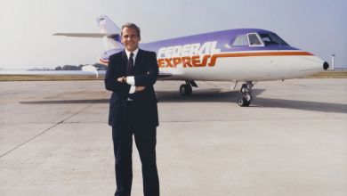 The FedEx founder, Fred Smith, stands in front of an original Federal Express jet from the 1970s.