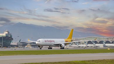 A yellow-tailed Air Hong Kong cargo jet begins its takeoff.