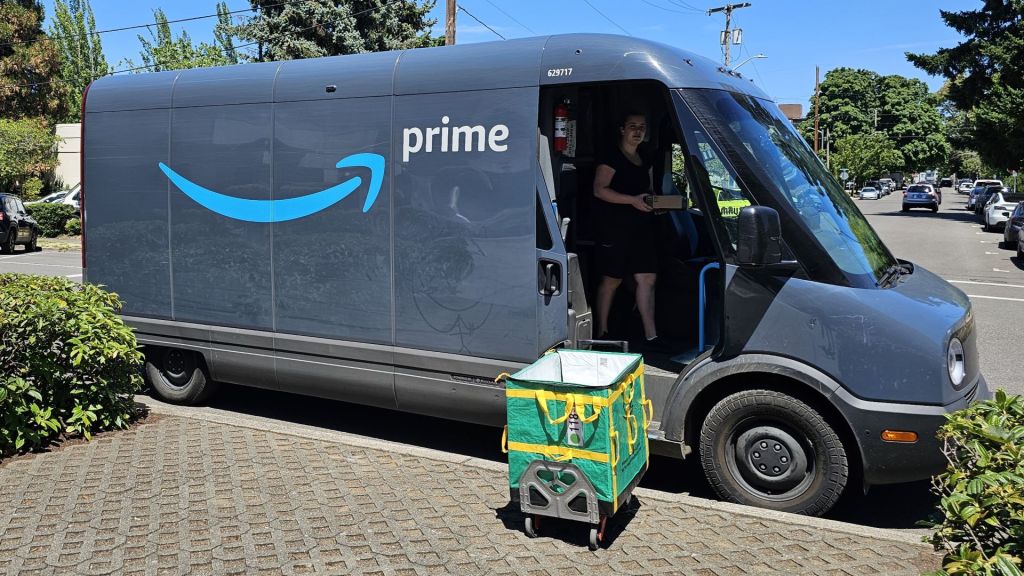 A two-tone blue Amazon Prime delivery van on a city street.